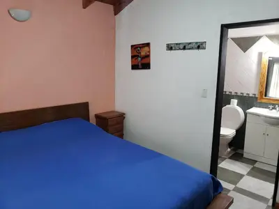 a bedroom with a blue bed and a sink at La casona in Merlo
