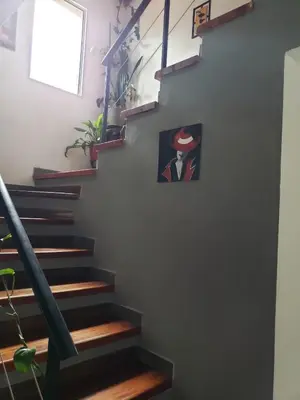 a staircase with a picture of a man on the wall at La casona in Merlo