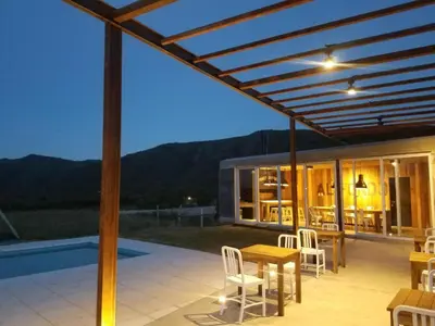a patio with a wooden table and chairs at Apart Carlos Paz Golf Country Club in Villa Carlos Paz