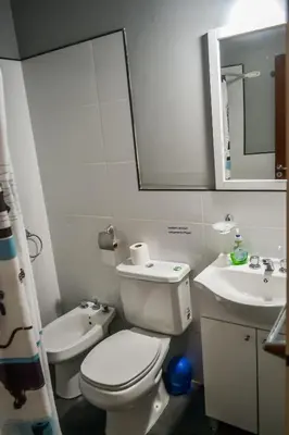 a bathroom with a toilet and a sink and a mirror at Dpto con Balcón- Rafael Nuñez - Cerro de las Rosas in Cordoba