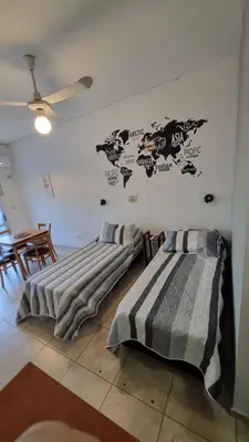 two beds in a room with a map on the wall at Dpto con Balcón- Rafael Nuñez - Cerro de las Rosas in Cordoba