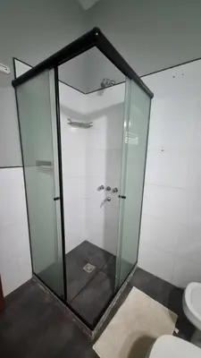 a glass shower in a bathroom with a toilet at Dpto con Balcón- Rafael Nuñez - Cerro de las Rosas in Cordoba