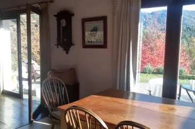 a dining room with a wooden table and chairs at Casona Familiar en La Cumbrecita in La Cumbrecita