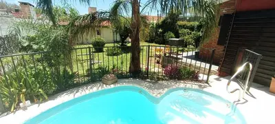 a swimming pool in a yard with a fence at Lago Azul in Embalse