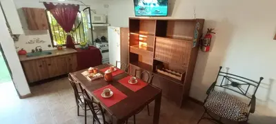 a kitchen with a table and chairs and a kitchen with a table and a kitchen at Lago Azul in Embalse