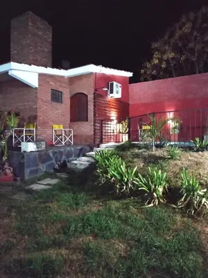 a house at night with lights on it at Lago Azul in Embalse