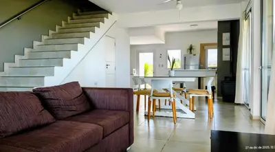 a living room with a couch and a dining room at Puerto del Aguila potrero de Garay Inbalo 01 in Los Reartes