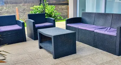 a group of wicker chairs and tables on a patio at Puerto del Aguila potrero de Garay Inbalo 01 in Los Reartes