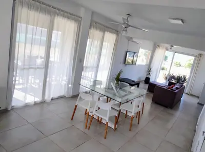 a living room with a table and chairs and a couch at Puerto del Aguila potrero de Garay Inbalo 01 in Los Reartes