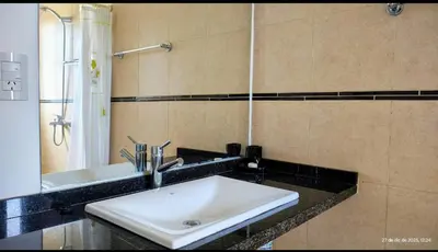 a bathroom with a white sink and a mirror at Puerto del Aguila potrero de Garay Inbalo 01 in Los Reartes