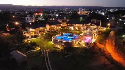 an aerial view of a city at night at ERNESTINA VILLAGE Resort Apart & suites in Villa Carlos Paz