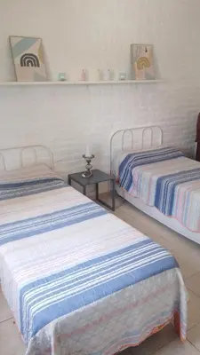a room with two beds and a table at Duplex, Córdoba zona norte in Cordoba