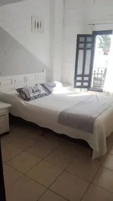 a large white bed in a room with a window at Duplex, Córdoba zona norte in Cordoba