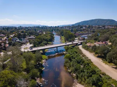 an aerial view of a bridge over a river at La Martinica in Villa Carlos Paz