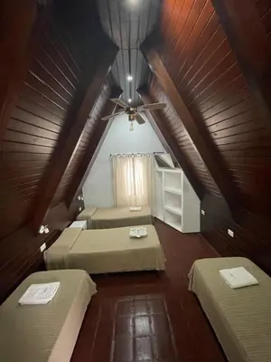 a attic room with two beds and a ceiling at La Martinica in Villa Carlos Paz