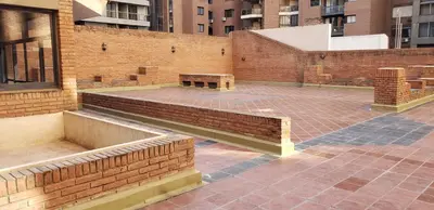 a brick patio with a bench on a brick building at Alquiler Temporal en Nueva Córdoba! in Cordoba