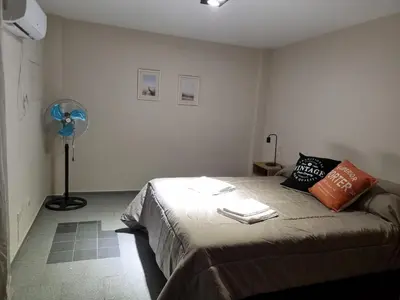a bedroom with a bed in a room with a fan at Alquiler Temporal en Nueva Córdoba! in Cordoba