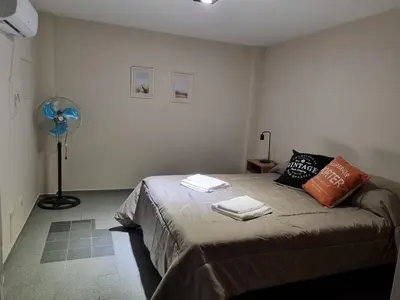 a bedroom with a bed with two towels on it at Alquiler Temporal en Nueva Córdoba! in Cordoba
