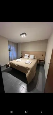 a bedroom with a large bed with two pillows at Alquiler Temporal en Nueva Córdoba! in Cordoba