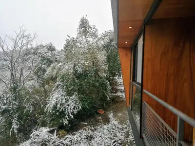 a view from the balcony of a house with snow at NIDO ARRIBA CABAÑAS in La Bolsa