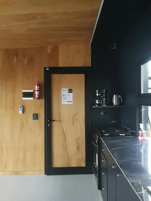 a door with a sign on it in a kitchen at NIDO ARRIBA CABAÑAS in La Bolsa