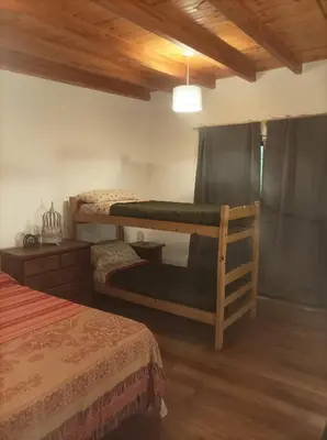 a bedroom with two bunk beds and a wooden ceiling at Torito's House 2 in Tanti