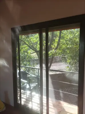 a sliding glass door with a view of a patio at Torito's House 2 in Tanti