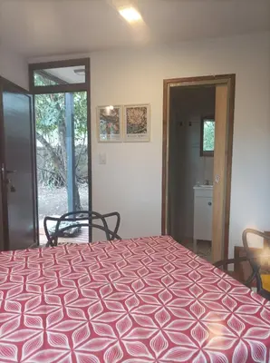 a bedroom with a bed with a purple comforter at Torito's House 2 in Tanti