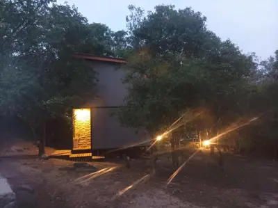 a building with a lit door and trees at night at Torito's House 2 in Tanti