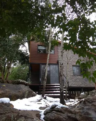 a house with snow on the ground in front of it at Torito's House 1 in Tanti