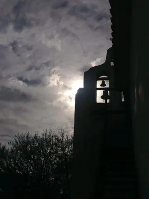 a sun setting behind a building with a bird on it at Torito's House 1 in Tanti