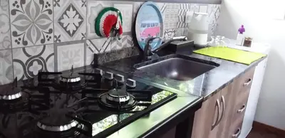 a kitchen with a sink and a stove top oven at Torito's House 1 in Tanti