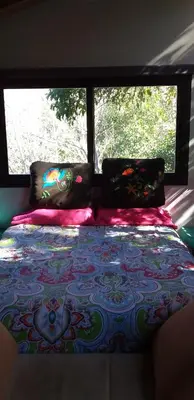 a bed in a room with two windows at Torito's House 1 in Tanti