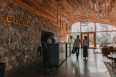 a lobby of a hotel with a stone wall at Böden Hotel & Spa, AKEN SOUL in Villa General Belgrano
