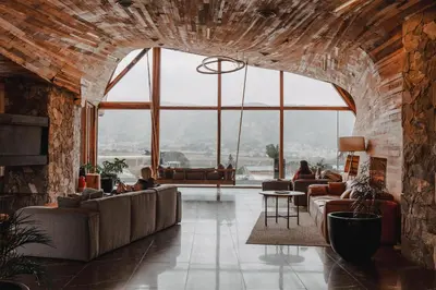 a living room with couches and a brick wall at Böden Hotel & Spa, AKEN SOUL in Villa General Belgrano