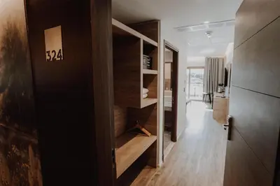 a room with a door open to a room with wooden floors at Böden Hotel & Spa, AKEN SOUL in Villa General Belgrano