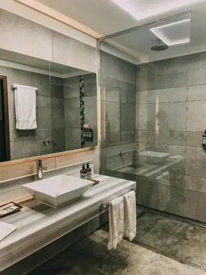 a bathroom with a sink and a tub and a mirror at Böden Hotel & Spa, AKEN SOUL in Villa General Belgrano