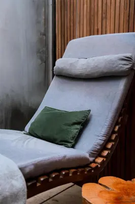 a wicker bed with a green pillow on it at Böden Hotel & Spa, AKEN SOUL in Villa General Belgrano