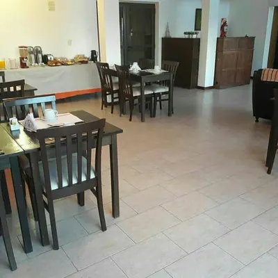a dining room with wooden tables and chairs at Hotel posada barrancas del sol in Merlo