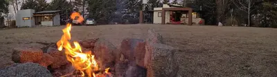 a fire pit in the middle of a yard at Cabañas Tierra Kamiare 2 in Villa Amancay