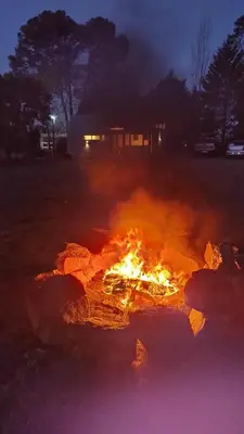 a fire is burning in a field at night at Cabañas Tierra Kamiare 2 in Villa Amancay