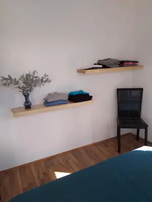 a room with a black chair and two shelves at Cabañas Tierra Kamiare 2 in Villa Amancay