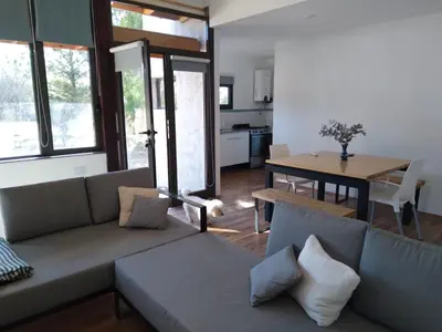 a living room with a couch and a table at Cabañas Tierra Kamiare 2 in Villa Amancay