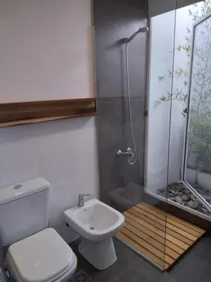 a bathroom with a shower and a toilet and a sink at Cabañas Tierra Kamiare 2 in Villa Amancay