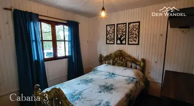 a bedroom with a bed and a window at Der Wandel in Villa General Belgrano