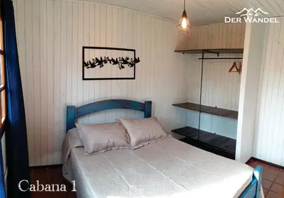 a bedroom with a blue bed in a room at Der Wandel in Villa General Belgrano