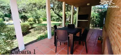 a porch with a table and chairs on it at Der Wandel in Villa General Belgrano