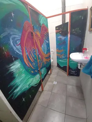 a bathroom with a painting of a fish on the wall at CASA ARTIGAS Hostel in Cordoba