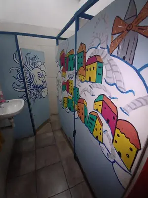 a bathroom with a mural of a city on the wall at CASA ARTIGAS Hostel in Cordoba