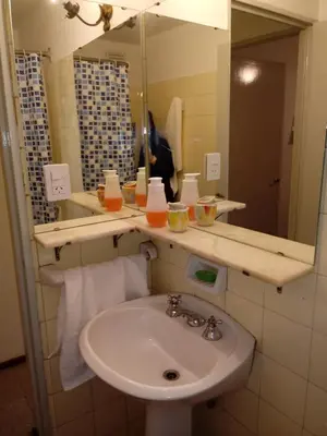 a bathroom with a sink and a mirror at hermoso Dpto. sobre La cañada en el centro de Córdoba capital-Argentina in Cordoba